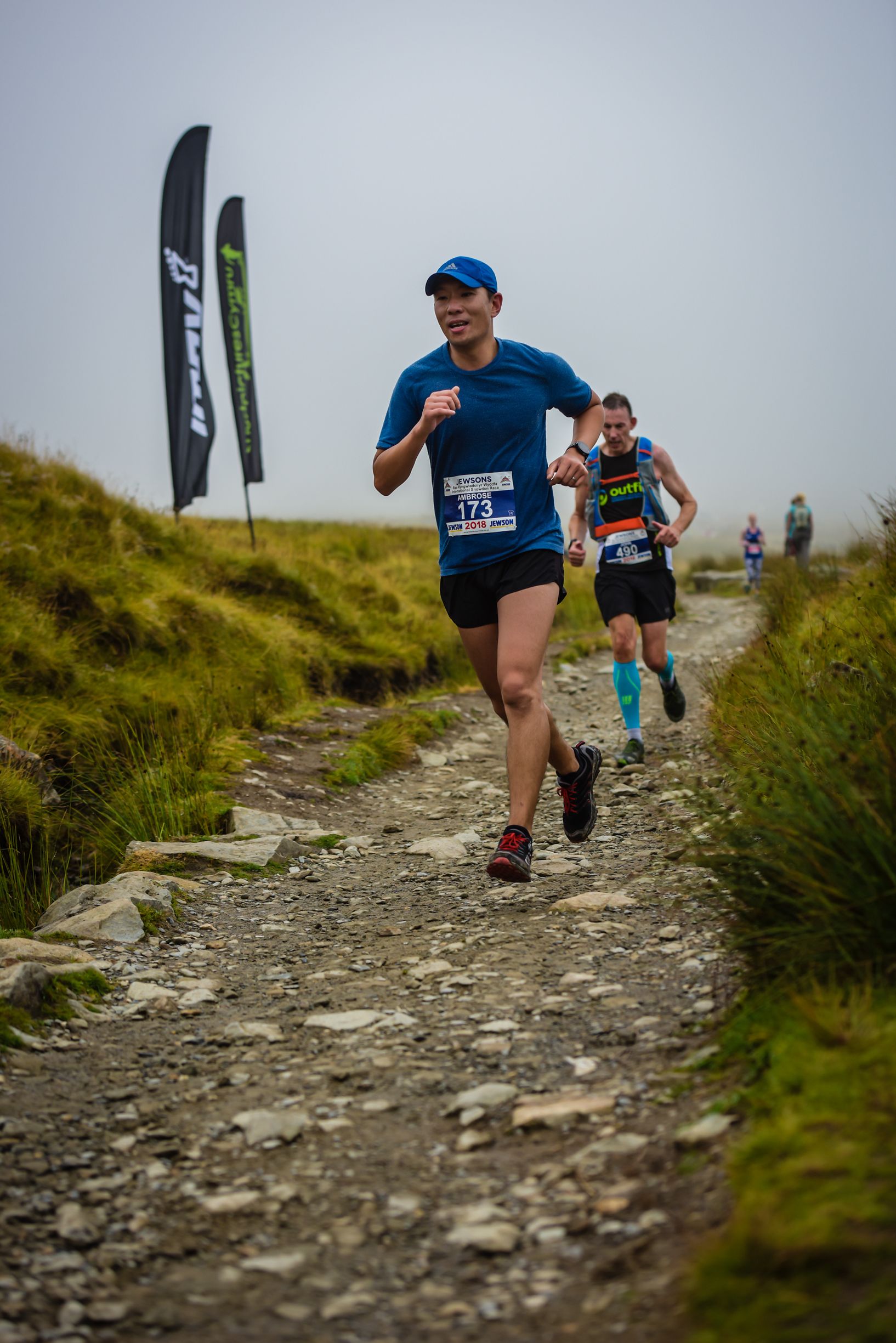 Teem Up founder participating in a running competition outdoors on a dirt trail